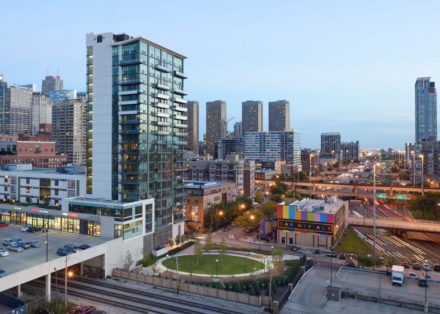 City skyline with Trio Apartments at dusk