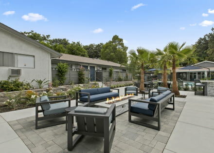 The Benson Apartments exterior facade and lounge area with firepit