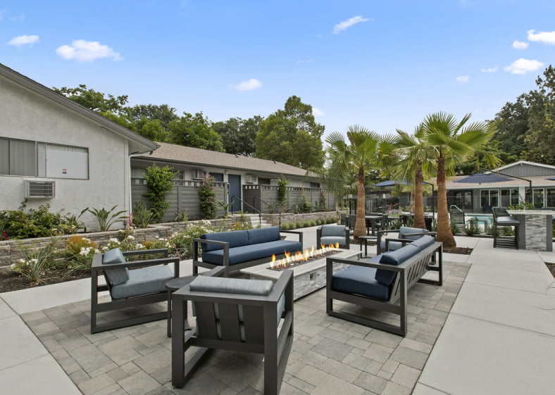 The Benson Apartments exterior facade and lounge area with firepit